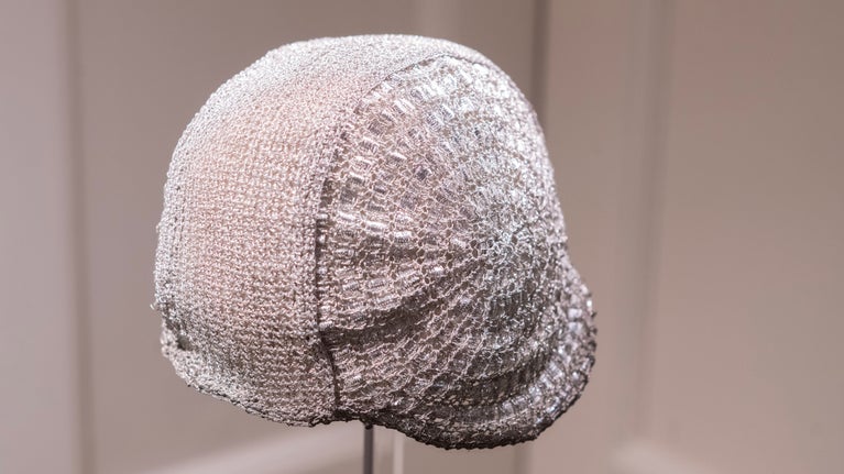 A cloche hat, crocheted from metallic yarn and ribbon, with a wired edge.